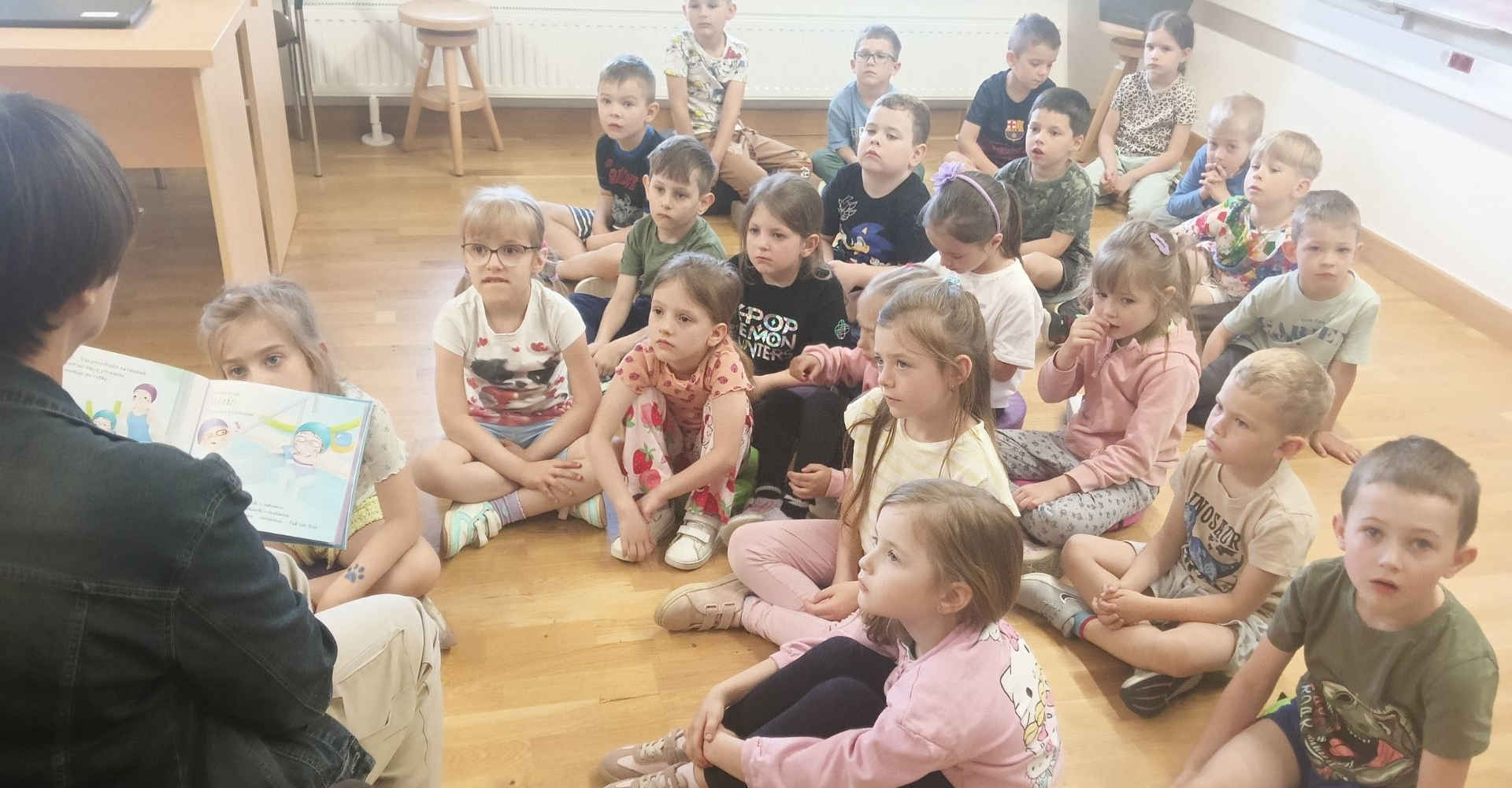 Dzieci oglądają bajkę z opiekunką